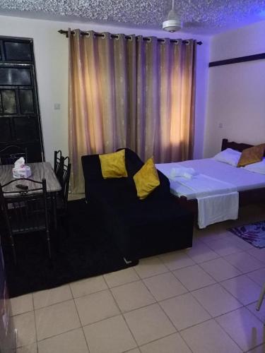 Postel nebo postele na pokoji v ubytování Mkombodzi Global Homes