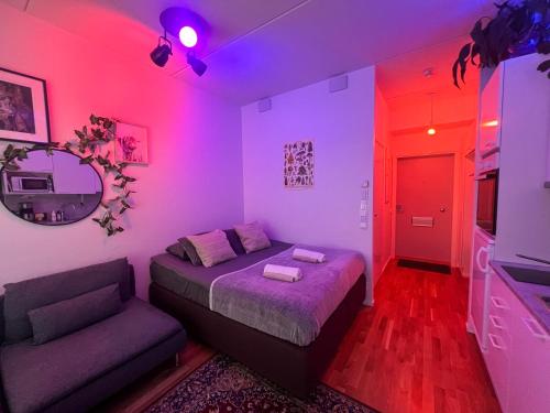 a bedroom with a bed and a couch and a mirror at Cozy studio in Vantaa, Near Airport with Parking in Vantaa