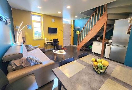 a living room with a couch and a table and a kitchen at Le Domaine du Templier - Maréchal in Borre