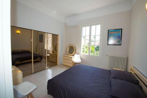 a bedroom with a blue bed and a mirror at Divine Villa with a large pool in the heart of Nice in Nice