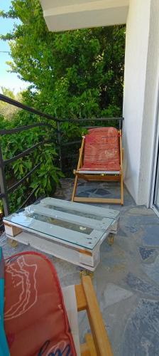a bed and two chairs sitting on a porch at Holiday Home Free your mind in Dobra Voda