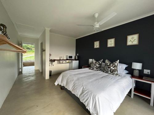 sypialnia z dużym łóżkiem z czarną ścianą w obiekcie Clearwater Farm Venue w mieście Port Edward
