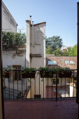 a building with potted plants on a fence at David Sweet Suite in Florence