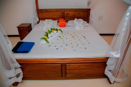 a bedroom with a bed with a white mattress at Rockery Villa Ayurveda in Bentota