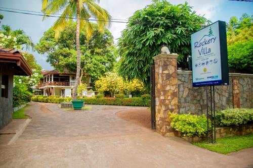 a sign for a driveway villa in front of a house at Rockery Villa Ayurveda in Bentota