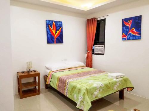a small bedroom with a bed and a window at Majestique Hotel Albay Bicol in Guinobatan