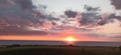 a sunset over the ocean with the sun in the sky at Alby suite in Termoli
