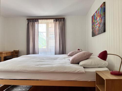 a bedroom with a large bed with a window at apartment Alpenrose in Saas-Grund