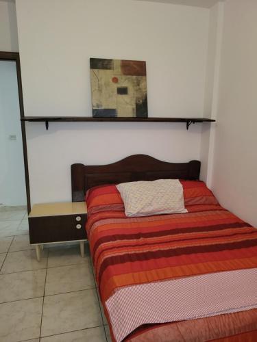 a bed in a room with a shelf above it at complexe doha marjane tetouan in Tétouan