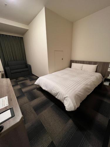 Postel nebo postele na pokoji v ubytování Dormy Inn Korakuen