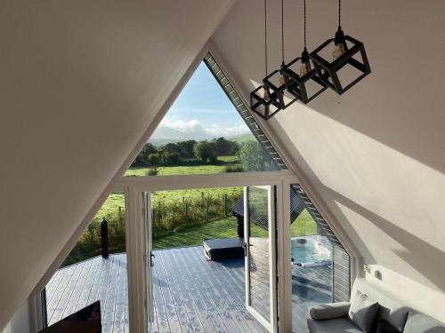 an attic room with a large window with a view at The Hut 45 in Newry