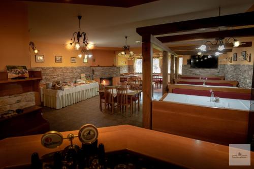 a restaurant with a kitchen and a dining room at Penzión na Bezovci in Nová Lehota
