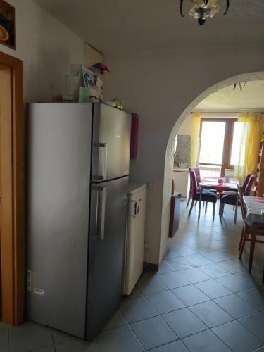 a kitchen with a refrigerator and a dining room with a table at Pension Nela in Klatovy