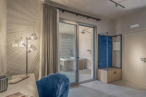 a bathroom with a glass shower and a sink at Terreforti Luxury Village in Agrigento