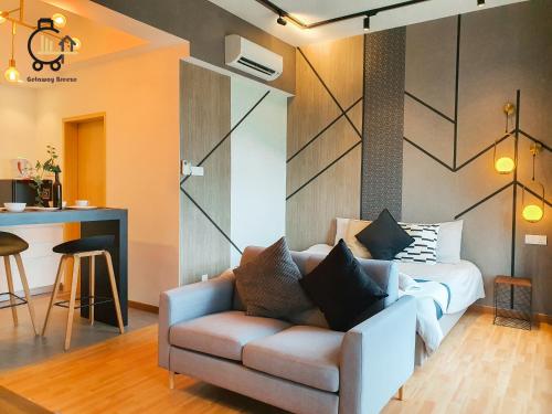 a living room with a couch and a kitchen at 1 min to Seaview & Sunrise Heart of Kuantan in Kuantan