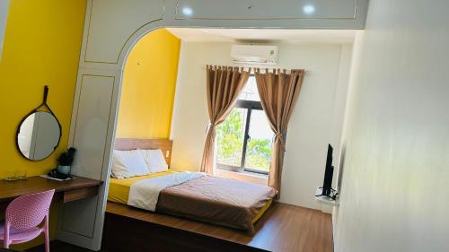 a bedroom with a bed and a window at Na Hostel Hue in Hue