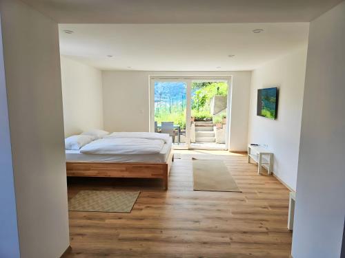 a bedroom with a bed and a sliding glass door at Charming Bella Hideout - Adults Only in Jesenice