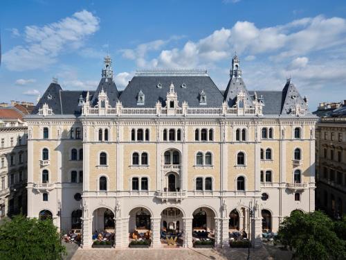 a large white building with a gray roof at W Budapest in Budapest