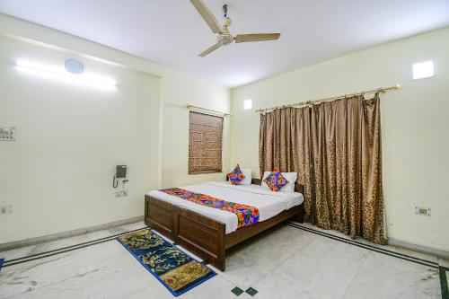 a bedroom with a bed and a window at FabExpress Ullash Residency in Kolkata
