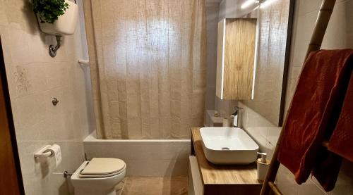 a bathroom with a toilet and a sink and a shower at Villa Colle dei Trulli Monopoli in Monopoli