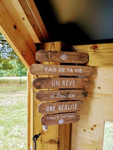 a wooden sign on the side of a cabin at La Borie du Chevrier in Sainte-Croix-de-Beaumont