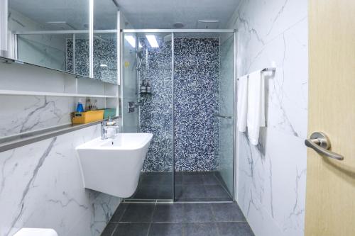 a bathroom with a white sink and a shower at Romang House in Incheon