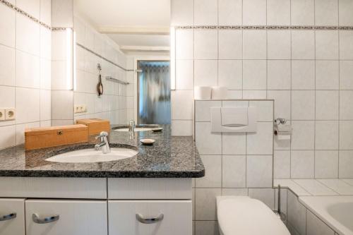 a bathroom with a sink and a toilet and a tub at Ferien Alm Alfret in Herrischried