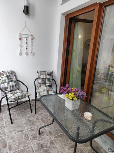 a living room with a glass table and chairs at Isidora Apartments in Zagora