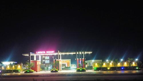 a gas station at night with a neon sign at Lakshya Resort in Gorakhpur