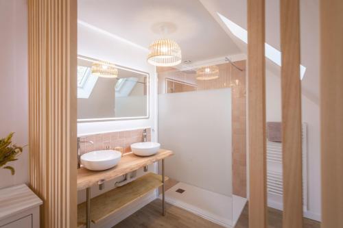 uma casa de banho com 2 lavatórios e um chuveiro em La Villa Maxine, vue mer et spa em Criel-sur-Mer
