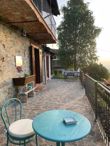 a blue table and chairs on a patio at Villa Biancospino - luxury and private villa in Langhe in Monforte dʼAlba