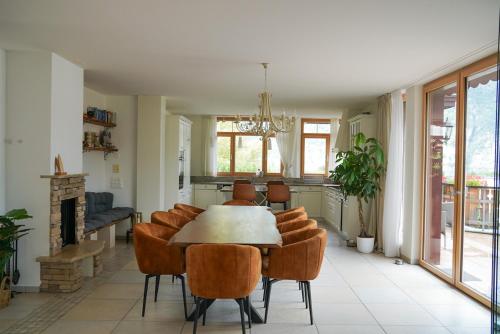 a dining room with a table and chairs at Doodle's Amazing Chalet -Walensee - Flumserberg - Churfirsten - Heidiland - Pool - Sauna in Mols