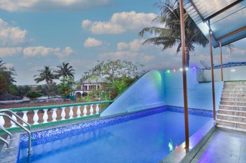 a swimming pool with a slide in a resort at Garava Villa Lonavala in Khandala