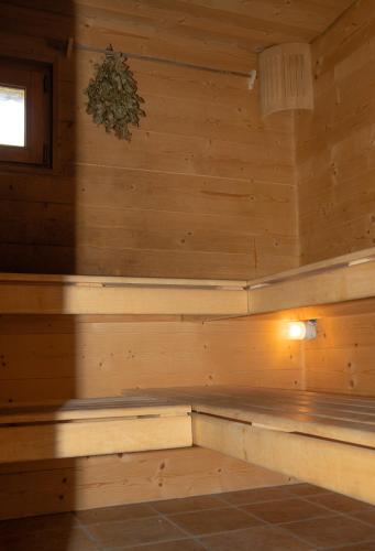 a sauna with wooden walls and a window at Doodle's Amazing Chalet -Walensee - Flumserberg - Churfirsten - Heidiland - Pool - Sauna in Mols