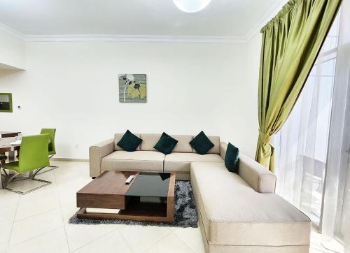 a living room with a couch and a coffee table at RH- Convenient 1BR, Central, near Mall of Emirates, Al Barsha1 in Dubai