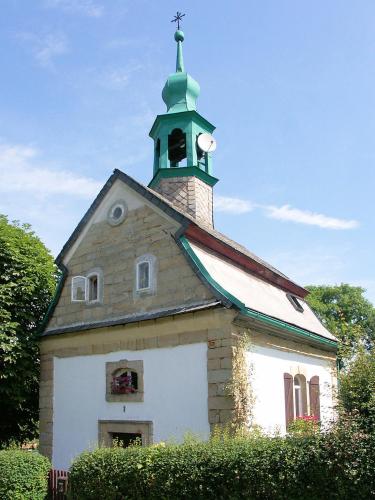 a church with a steeple on top of it at Apartmán Levandule in Mařenice