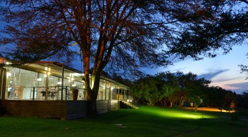 a building with a tree in front of it at Cresta Lodge Harare in Harare