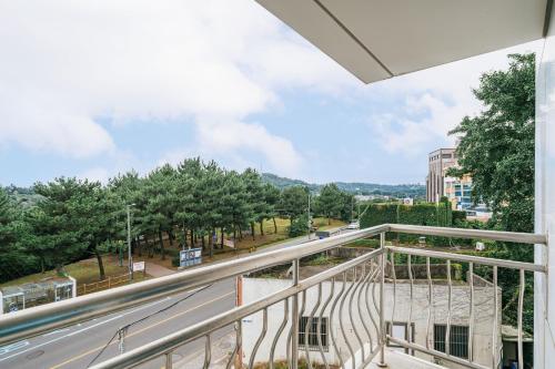 a balcony with a view of a street at Heyy Seogwipo Hotel in Seogwipo