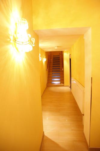 a hallway with a light on the wall and a staircase at Hotel City Inn Hamburg-Mitte in Hamburg