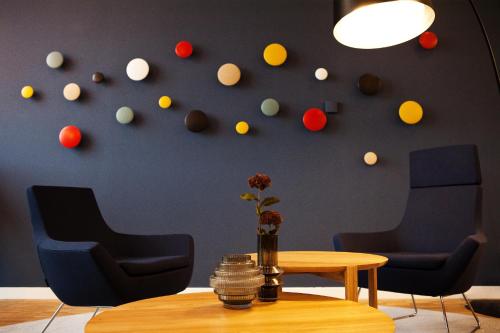 a room with a table and chairs and a wall with balls at Holiday Inn Express Bochum by IHG in Bochum