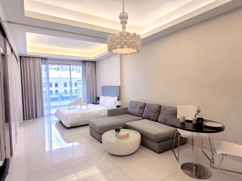 a living room with a couch and a bed at Damas Residence Kuala Lumpur in Kuala Lumpur