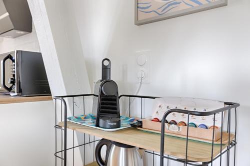 a iron cart with a ironing board with a blender on it at Le Magnolia - A 10 minutes de Disneyland in Lagny