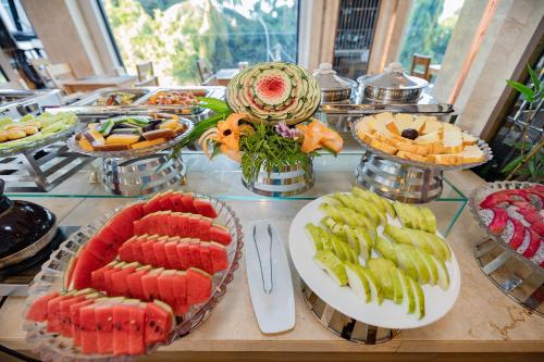 a buffet of food on a table with plates of food at An Vista Hotel in Nha Trang