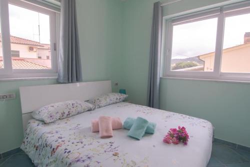 1 dormitorio con 1 cama con 2 toallas y flores en Appartamento Sogno Marino, en Portoferraio
