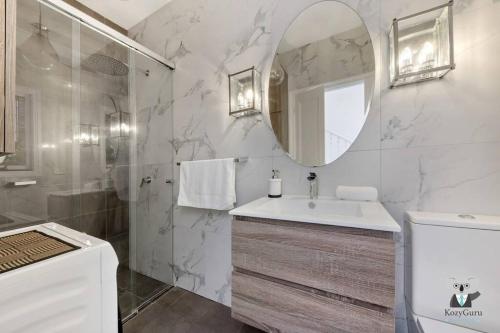a bathroom with a sink and a mirror at Glebe Cozy 2 Bedroom Stunning Terrace House / NGL058 in Sydney