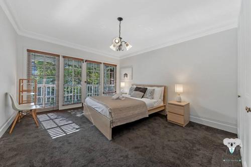 a bedroom with a bed and a large window at Glebe Cozy 2 Bedroom Stunning Terrace House / NGL058 in Sydney