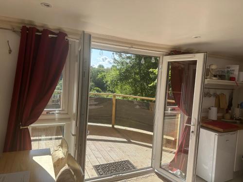 a sliding glass door with a view of a patio at Unique Orchard Lodge for couples with hot tub in Strathaven