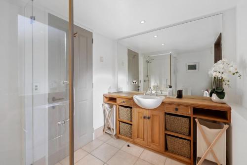 a bathroom with a sink and a shower at Beautifully styled central home in Queenstown