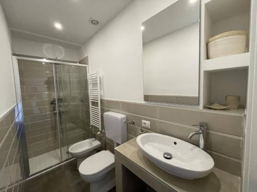 a bathroom with a toilet and a sink and a shower at IseoLakeRental - Casa Il Nido in Fonteno