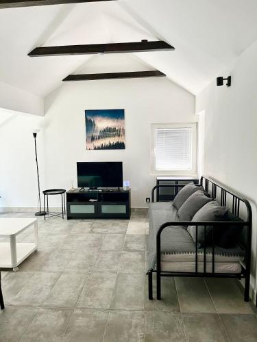 a living room with a bed and a television at Open Space Apartment in Belgrade